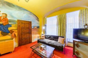 a living room with a couch and a painting on the wall at Residence Seven Angels in Prague