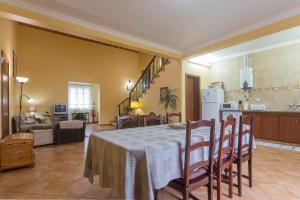 a kitchen and a dining room with a table in a room at Apartamentos em Casa da Avó Inês in Porto Formoso