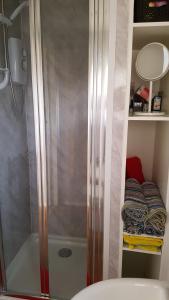 a shower stall in a bathroom with a sink at For-Get-Me-Not Chalet semi detached in Bridlington +18 photos