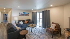 a living room with a couch and a table at Moab Redcliff Condos in Moab