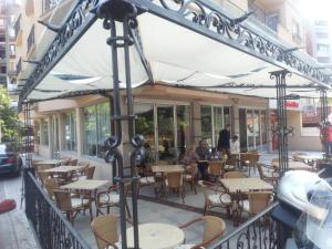 an outside seating area of a restaurant with tables and chairs at Park Srce Apartments in Arandelovac