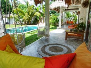 a living room with a couch and a pool at Villa Rustic Charm in Gili Trawangan