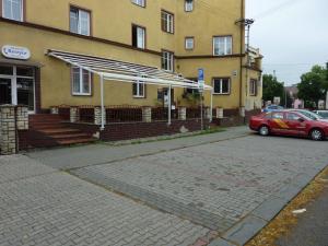 a red car parked in front of a building at Hotel Paradise in Ostrava