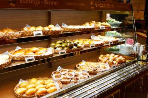 a display case in a bakery filled with lots of pastries at Hotel Konigs-Krone Kobe in Kobe