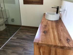 a bathroom with a sink on top of a wooden counter at Gran casa del lago in Villa Ciudad de America +14 photos