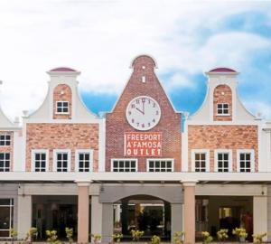 a large building with a clock on top of it at SHA GATHERING ALOR GAJAH BUNGALOW, A FAMOSA MELAKA in Melaka