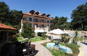 a resort with a swimming pool and a building at Glikadi Hotel in Limenas