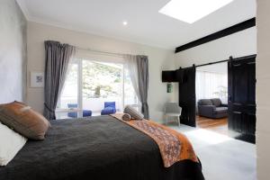 
a bedroom with a large bed and a large window at Hidden Treasure in Fremantle
