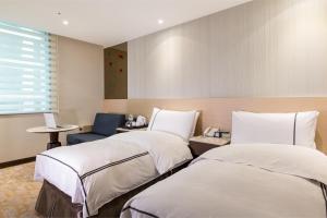 Postel nebo postele na pokoji v ubytování K Hotel Tianjin