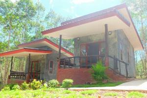 a small house with a large window and a porch at Ban Choengkao in Ko Kood