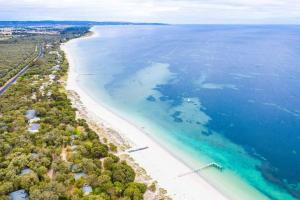 
a beach with a large body of water at Siesta Park Holiday Resort in Busselton

