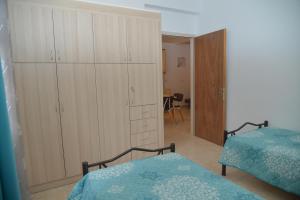 a bedroom with two beds and a large closet at River house fully renovated & equipped 10' from DT in Potamós