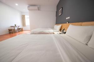 a bedroom with a large white bed in it at Deer Traveler 行鹿 in Yuchi +79 photos