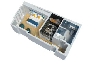 een kleine indeling van een kamer met een bed bij MM Suites Marlot in Reims