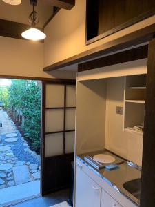 a kitchen with a sink and a toilet in it at 近江の町家 門 in Omihachiman