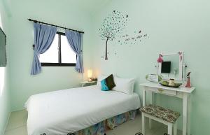 Vuode tai vuoteita majoituspaikassa Yilan Greenbird of Happiness B&B