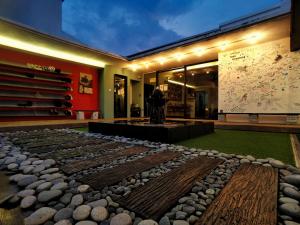 a building with a display of rocks on the ground at Beds In Garden Hostel in Ipoh