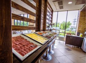 a buffet with meat and other food on a table at East Time Hotel in Minsk