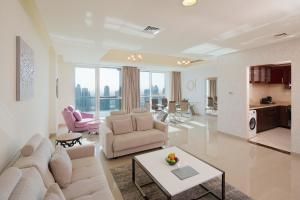 a living room filled with furniture and a large window at Barceló Residences Dubai Marina in Dubai