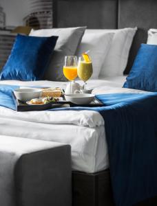 a table with food and drinks on a bed at Aquaperla Hotel & SPA in Chişinău