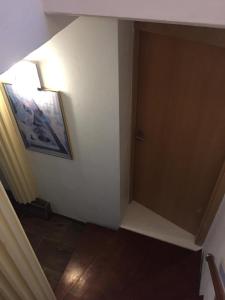 a hallway with a door and a picture on the wall at WOHLFÜHLOASE - Zimmer, Appartment - im Herzen STARNBERGS in Starnberg