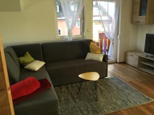 a living room with a couch and a table at Haus Ranten 105 in Ranten