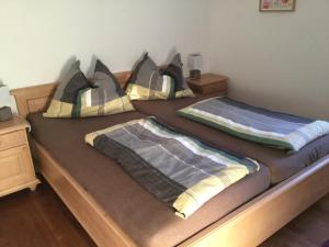 two beds with blankets and pillows on them in a bedroom at Haus Ranten 105 in Ranten