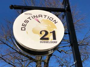 a sign on a pole on a street at Hotel Destination 21 in Düsseldorf