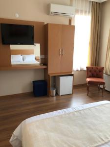 a hotel room with a bed and a chair at Ottoman's Pearl Hotel in Istanbul