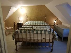 a bedroom with a bed in a attic at La "charcuterie" GREBER in Beauvais