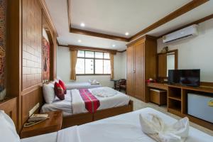 Säng eller sängar i ett rum på Magnific Guesthouse Patong