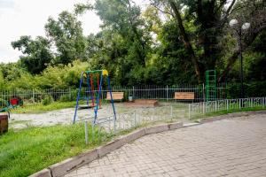 a playground with two benches in a park at Gostevoy Dom Stroganovikh in Kursk