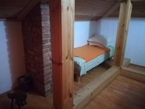 a small room with a bed in a attic at Guest House Edelweiss in Koprivshtitsa