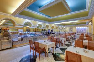 a restaurant with tables and chairs and a counter at Senator Marbella Spa Hotel in Marbella