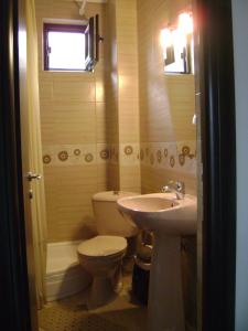 a bathroom with a toilet and a sink at Vila Patricia in Eforie Nord +68 photos