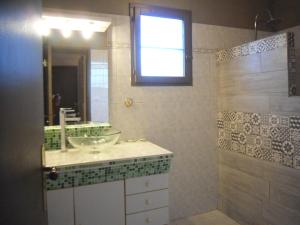 a bathroom with a sink and a mirror and a shower at chambre les flamants vue sur les étangs petit déjeuner compris in Saintes-Maries-de-la-Mer