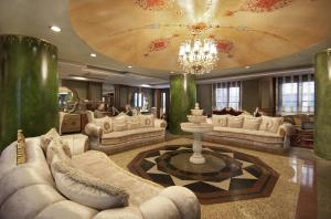a large living room with couches and a chandelier at Hotel Sapphire in Istanbul