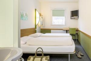 a hospital room with two beds and a sink at ibis budget Dueren West in Düren - Eifel
