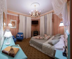 a bedroom with a large bed and a chandelier at Trezzini Art Hotel in Saint Petersburg