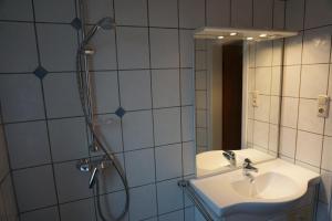 a bathroom with a shower and a sink and a mirror at Lilis Ferienwohnung in Munster im Heidekreis +20 photos