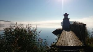 a lighthouse on a dock on a body of water at Kanalmagasinets Pensionat in Söderköping