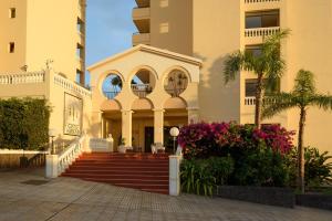 a building with a staircase in front of a building at Castle Harbour Official in Los Cristianos