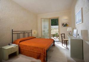 מיטה או מיטות בחדר ב-Masseria L'Antico Frantoio