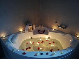 a bathroom with a tub with candles in it at Balcón de la Len in Quintana de Soba