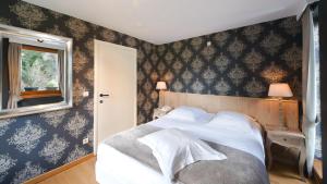 Postel nebo postele na pokoji v ubytování Hotel Le Beau Séjour