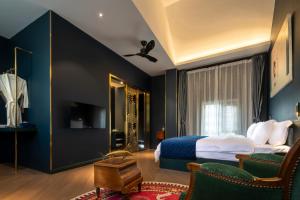 a bedroom with a king sized bed with blue walls at Moon and Chalice Boutique Hotel in Kunming