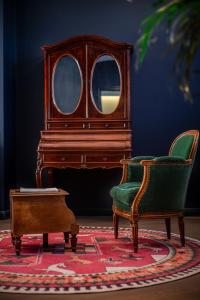 a room with a piano and two chairs and a table at Moon and Chalice Boutique Hotel in Kunming