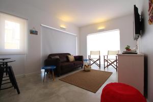 uma sala de estar com um sofá e uma mesa em House Beach em Costa da Caparica