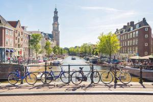 bikes are parked in front of a clock tower at St Christophers Inn at The Winston in Amsterdam