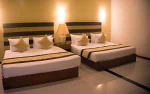 Llit o llits en una habitació de Beach Corridor Hotel & Spa